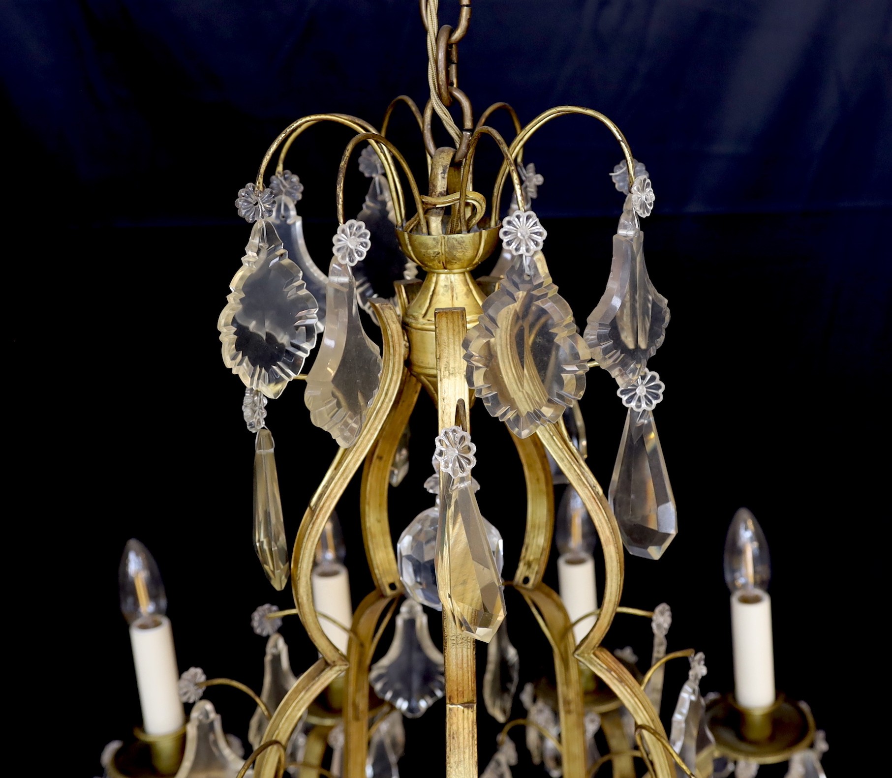An early 20th century French silver and bronze and cut glass ten light chandelier hung with lozenge and tear shaped drops, drop 82cm. width 60cm